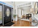 Welcoming home foyer with hardwood floors and views into the dining room with natural light at 101 Silk Leaf, Cary, NC 27518