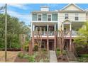 Inviting townhouse with a classic facade, featuring a lovely front porch and well-maintained landscaping at 1029 Frank Page Dr, Cary, NC 27519