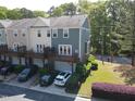 Rear view of townhouse featuring private decks, garage parking, and manicured landscaping at 1029 Frank Page Dr, Cary, NC 27519