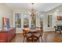 Charming breakfast room with large windows, chandelier, and access to the deck at 108 Monarch Way, Cary, NC 27518