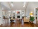 Bright living room with skylights, fireplace, and large windows with views of the backyard at 108 Monarch Way, Cary, NC 27518