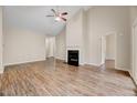Inviting living room featuring a cozy fireplace, vaulted ceilings, and hardwood floors at 1123 Claret Ln, Morrisville, NC 27560