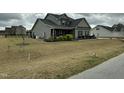 A spacious backyard enclosed by a black fence provides privacy and room for outdoor fun at 116 Polenta Fields Dr, Smithfield, NC 27577