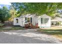 Cozy one-story home featuring a gravel driveway, quaint porch, and comfortable outdoor space at 116 W Mciver St, Zebulon, NC 27597
