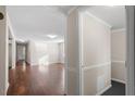 Bright hallway leading into a spacious living area with hardwood floors and neutral walls at 116 W Mciver St, Zebulon, NC 27597