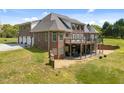 Brick home with a spacious wooden deck perfect for outdoor entertaining, offering views of the surrounding landscape at 1174 Robertson Rd, Roxboro, NC 27574