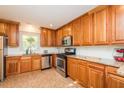 Spacious kitchen with wood cabinets, stainless steel appliances, and granite countertops at 127 Long Shadow Pl, Durham, NC 27713