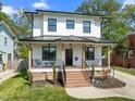 Inviting two-story home featuring a covered front porch and manicured lawn at 1312 Lancaster St, Durham, NC 27701