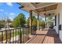 Spacious covered front porch featuring wood ceiling, columns and black metal railing at 1312 Lancaster St, Durham, NC 27701
