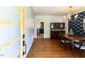 Elegant dining room with hardwood floors, stylish wallpaper, and a chandelier at 1317 Kelly Rd, Garner, NC 27529