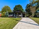 Inviting single-story home with a spacious driveway and a well-maintained lawn at 1317 Kelly Rd, Garner, NC 27529