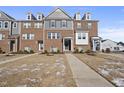 Beautiful brick townhome with welcoming entrance and well-maintained front yard at 1335 Herb Garden Way, Apex, NC 27502