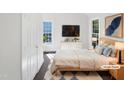 Staged bedroom with a neutral palette, modern furniture, and ample natural light at 1405 Cross Link Rd, Raleigh, NC 27610
