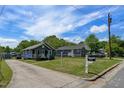 View of houses with well-kept lawns and a long driveway leading to one of the homes at 1542 Albright Ave, Burlington, NC 27215