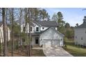 Lovely two-story home with a two-car garage, surrounded by mature trees in a serene setting at 157 Maplewood Dr, Sanford, NC 27332