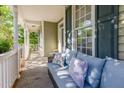 Relaxing front porch featuring a comfortable couch with decorative pillows at 161 Fort Jackson Rd, Morrisville, NC 27560