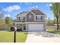 Charming two-story home with a well-manicured lawn and a two-car garage at 166 Old Field Loop Loop, Sanford, NC 27332