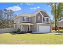 Charming two-story home with a well-manicured lawn and a two-car garage at 166 Old Field Loop Loop, Sanford, NC 27332