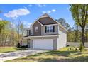 Charming two-story home with a well-manicured lawn and a two-car garage at 166 Old Field Loop Loop, Sanford, NC 27332