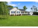 Lovely single Gathering home on a sprawling lawn with a large shop building and manicured landscaping at 175 Bill Avery Rd, Coats, NC 27521