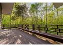 Spacious wooden deck overlooking lush green trees, ideal for outdoor relaxation and entertaining at 195 Nicks W Bnd, Pittsboro, NC 27312