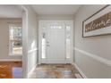 Welcoming foyer with a decorative tile floor, paneled walls, and a charming welcome sign at 2009 Mallard Ln, Raleigh, NC 27609