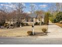 Inviting home featuring neutral siding, mature landscaping, and a paved driveway at 2009 Mallard Ln, Raleigh, NC 27609