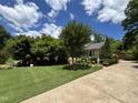 Inviting home with lush lawn and mature trees, perfect for outdoor enjoyment at 2009 Mallard Ln, Raleigh, NC 27609