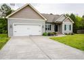 Charming single-Gathering home featuring a well-maintained lawn, an attached garage, and a long driveway at 201 Lexington Park Dr, Oxford, NC 27565
