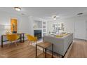 Open-concept living room featuring hardwood floors, fireplace, a work station, and a neutral color palette at 206 Black Bird Ct, Cary, NC 27511