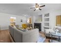 Bright living room with hardwood floors, a fireplace, built-in shelves, and comfortable seating at 206 Black Bird Ct, Cary, NC 27511