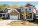 Charming two-story home with stone accents, a two-car garage, and a beautifully landscaped front yard at 2221 Holtwood Way, Apex, NC 27523
