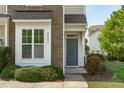 The welcoming entrance boasts a stylish front door, manicured bushes and a well-maintained lawn at 2227 Rocky Bay Ct, Cary, NC 27519