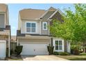 This home offers a two-car garage with a long driveway and a beautifully landscaped yard with mature trees at 2227 Rocky Bay Ct, Cary, NC 27519