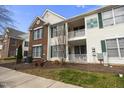 Charming townhome exterior featuring private balconies, well-kept landscaping, and building address markers at 2421 Kudrow Ln, Morrisville, NC 27560