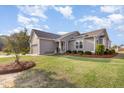 Inviting single-story home boasts a beautiful lawn, manicured landscaping, and an attached two-car garage at 25 Cornfield Ln, Benson, NC 27504