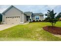 Charming single-story home features a manicured lawn, two-car garage, and traditional curb appeal at 25 Cornfield Ln, Benson, NC 27504