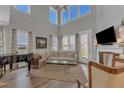Bright living room with high ceilings, fireplace, large windows, and a grand piano at 2528 Forge Village Way, Apex, NC 27523