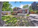 A charming home with a welcoming front porch, lush greenery, and a well-kept lawn at 2904 Falkirk Pl, Raleigh, NC 27604