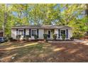 Inviting single-story house featuring blue shutters, complemented by a well-maintained lawn and trees at 3116 Henslowe Dr, Raleigh, NC 27603