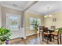 Bright dining room featuring wood floors, a chandelier, and a view of the outdoors at 312 Loon Ct, Graham, NC 27253