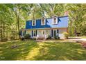 Charming two-story home with blue shutters, a matching roof, and a well-manicured lawn at 3312 Shannon Cir, Apex, NC 27539