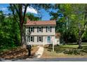 Charming two-story home with neutral siding, black shutters, and a well-manicured lawn at 3317 E Jameson Rd, Raleigh, NC 27604