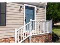 Close-up of the blue front door with white trim and stairs leading to front door at 3317 E Jameson Rd, Raleigh, NC 27604