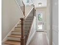 Welcoming entryway featuring hardwood floors, a staircase with iron railings, and natural light at 337 Merrywood Dr, Raleigh, NC 27610