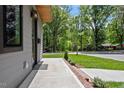 Inviting front porch featuring a concrete walkway and lush green landscaping at 337 Merrywood Dr, Raleigh, NC 27610