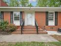 Inviting brick front porch and entry stairs, perfect for relaxing and enjoying the outdoors at 3806 Sue Ln, Raleigh, NC 27604