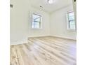 Bright bedroom featuring neutral walls and modern floors with a window offering natural light at 409 Neathery St, Henderson, NC 27536