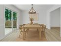 Charming dining area with a modern chandelier, stylish seating, and sliding door to the outside deck at 419 Joy Dr, Garner, NC 27529
