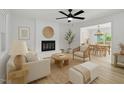 Bright living room featuring a cozy fireplace, hardwood floors, and elegant neutral décor at 419 Joy Dr, Garner, NC 27529